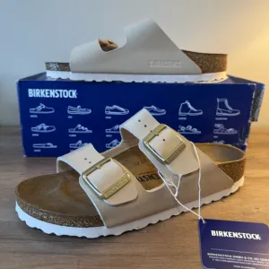 Birkenstock Arizona Gold Buckle High Shine Sandal in Sand Color