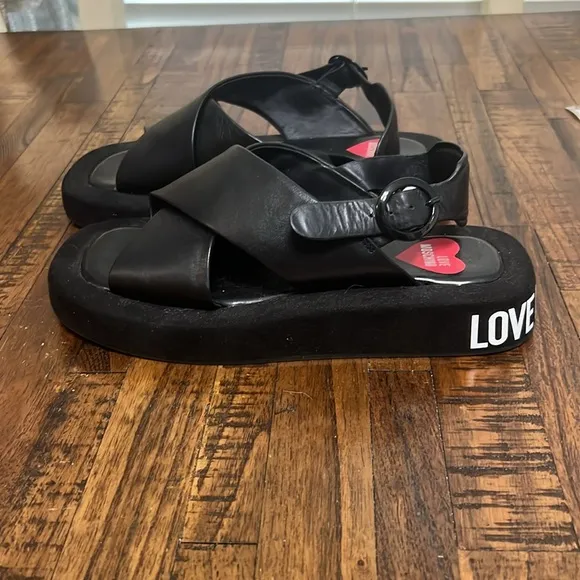 Love Moschino Sandals Black leather crossover pattern with buckle closure sz 38